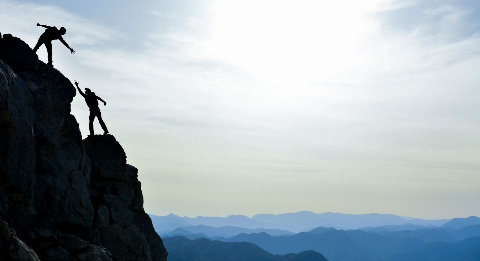 teamwork climbing a mountain